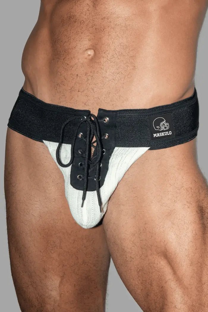 Maskulo Ken Gridd-Iron American Football Jockstrap in black and white. Features mesh pouch, 3D logo patch, lacing, and wide waistband.