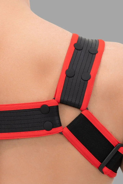 Outtox black and red body harness with metal snaps. Stylish adjustable straps for a secure and comfortable fit, perfect for clubwear.
