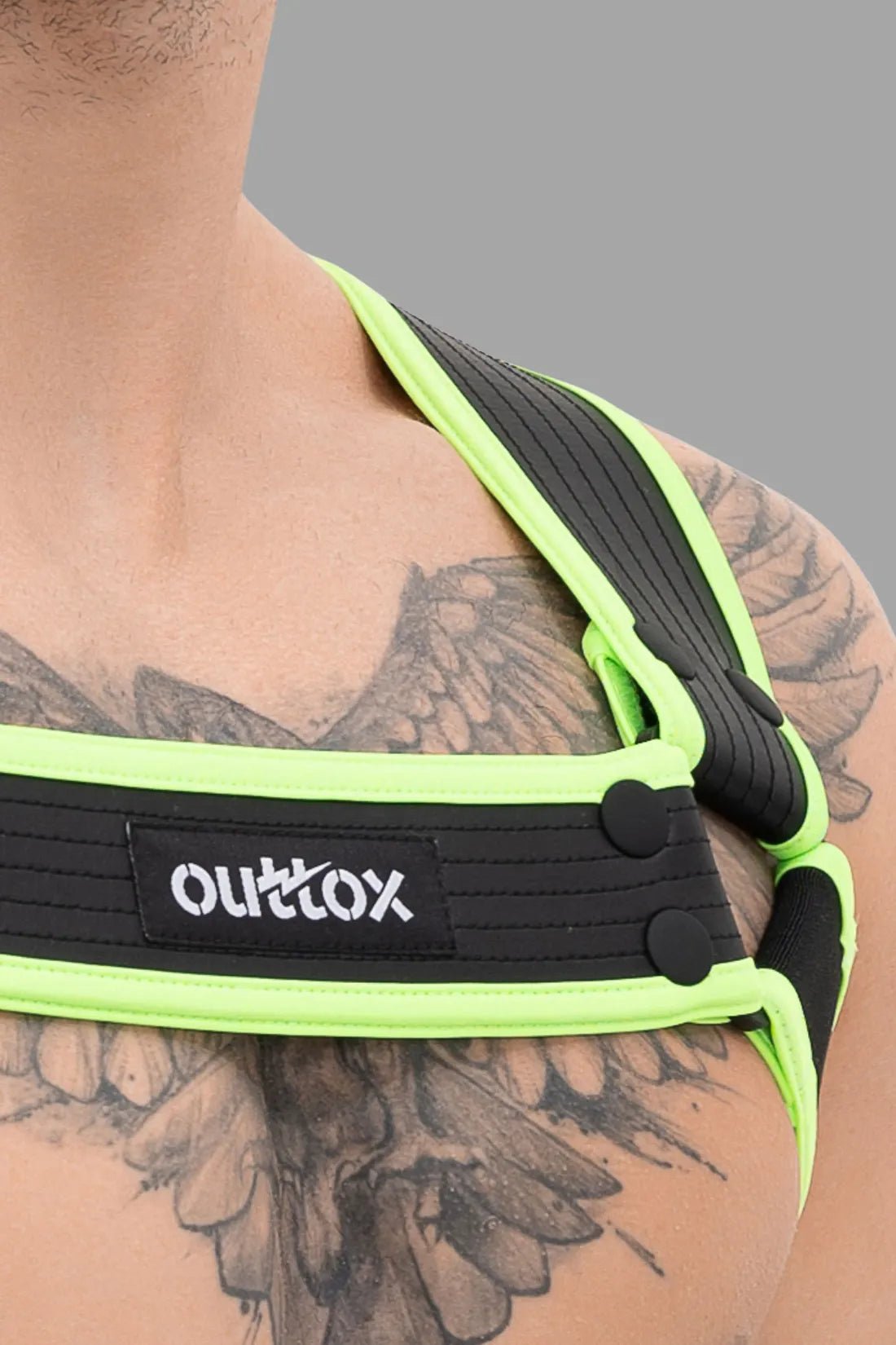 Outtox Body Harness with Snaps in Black and Neon Green from Maskulo, polyester-blend with integrated cockring for comfortable fit.