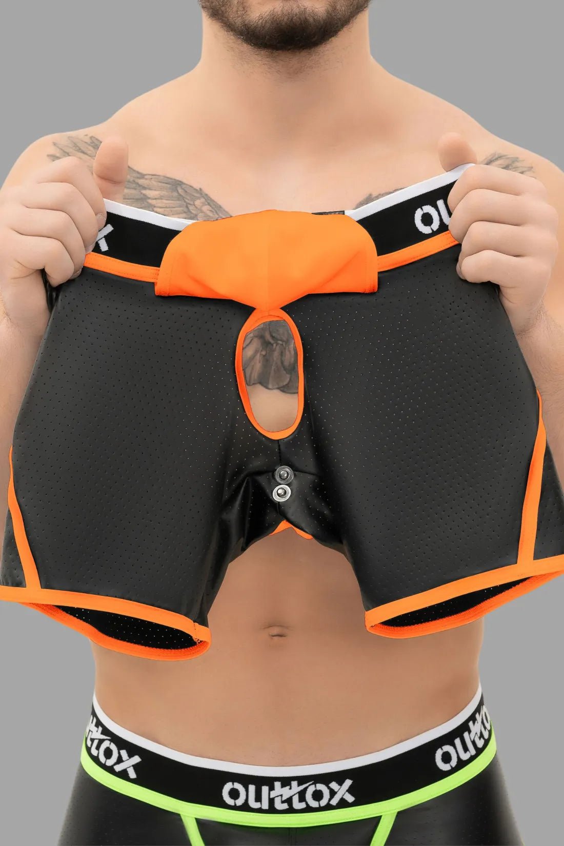 Outtox open rear shorts with snap codpiece in neon orange. Bold men&